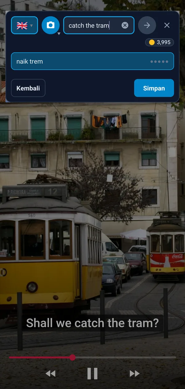 Tombol mengambang di atas video: frasa subtitel apanhar o elétrico dengan terjemahan take the tram dan catch the tram